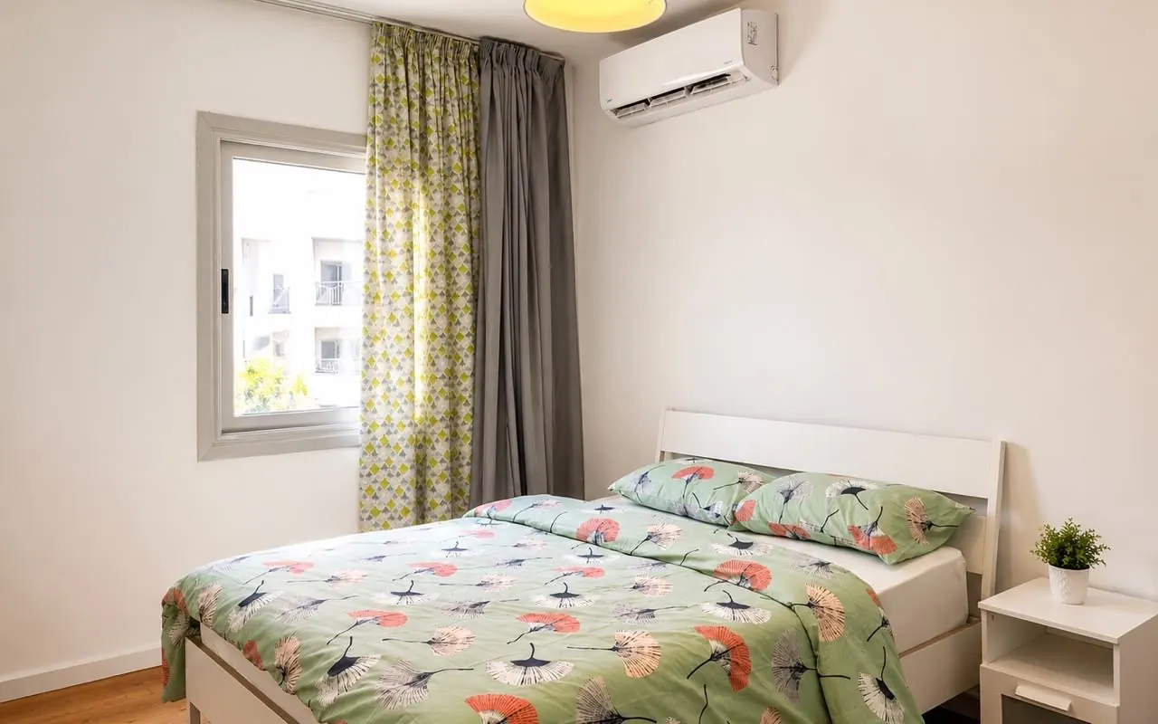 Bedroom with floral linens and garden window
