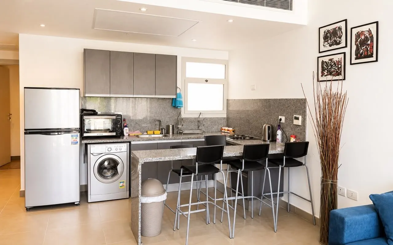 Open kitchen with breakfast bar and washer