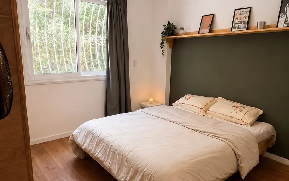 Second bedroom with green feature wall