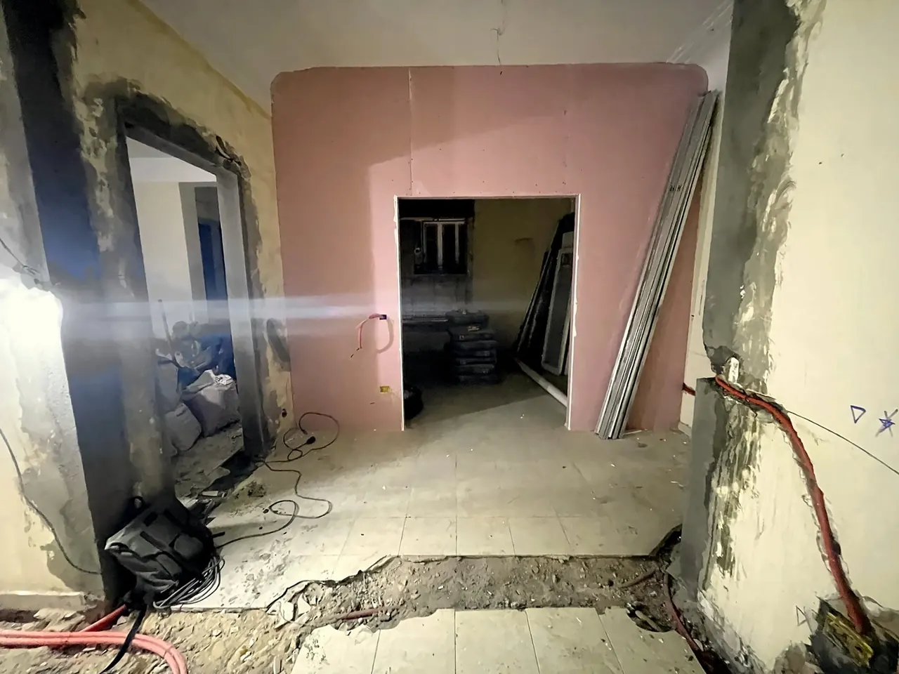 The flat before refurbishment — bare walls and exposed services